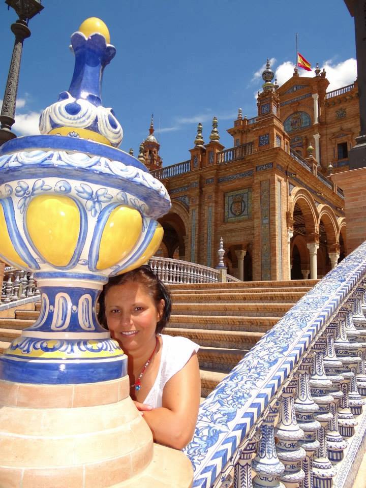 Attractive woman smiling in the picture with a beautiful castle behind her